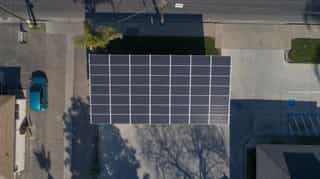 A galvanized solar carport structure providing shade and generating energy